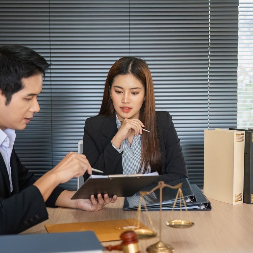 Attorney and business owner reviewing MCA debt documents together