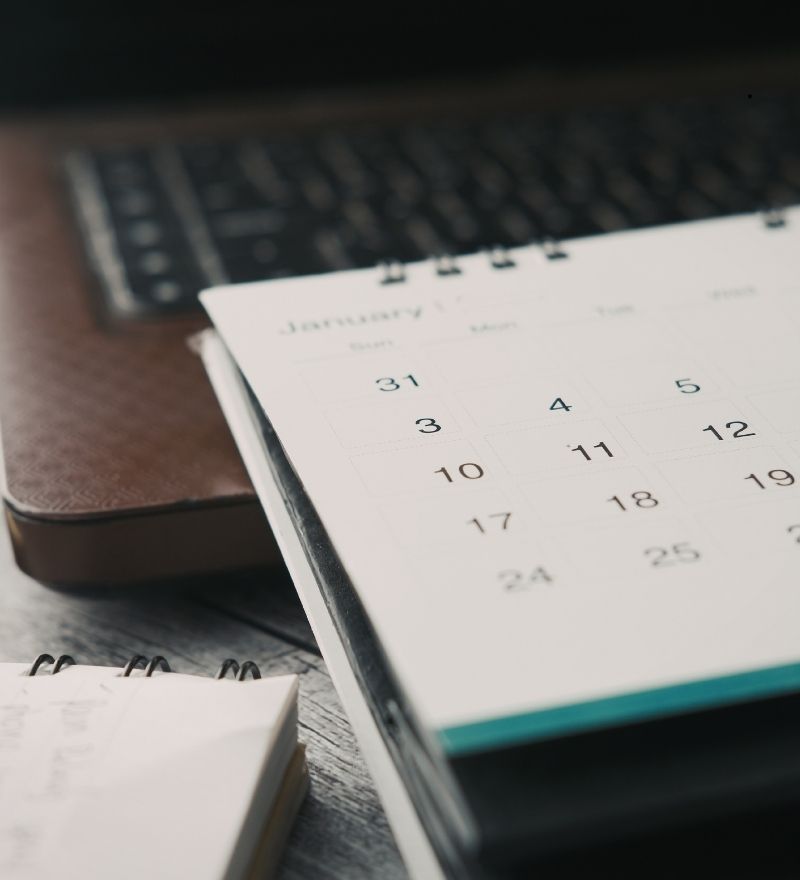 Organized documents and calendar representing the MCA debt settlement timeline process