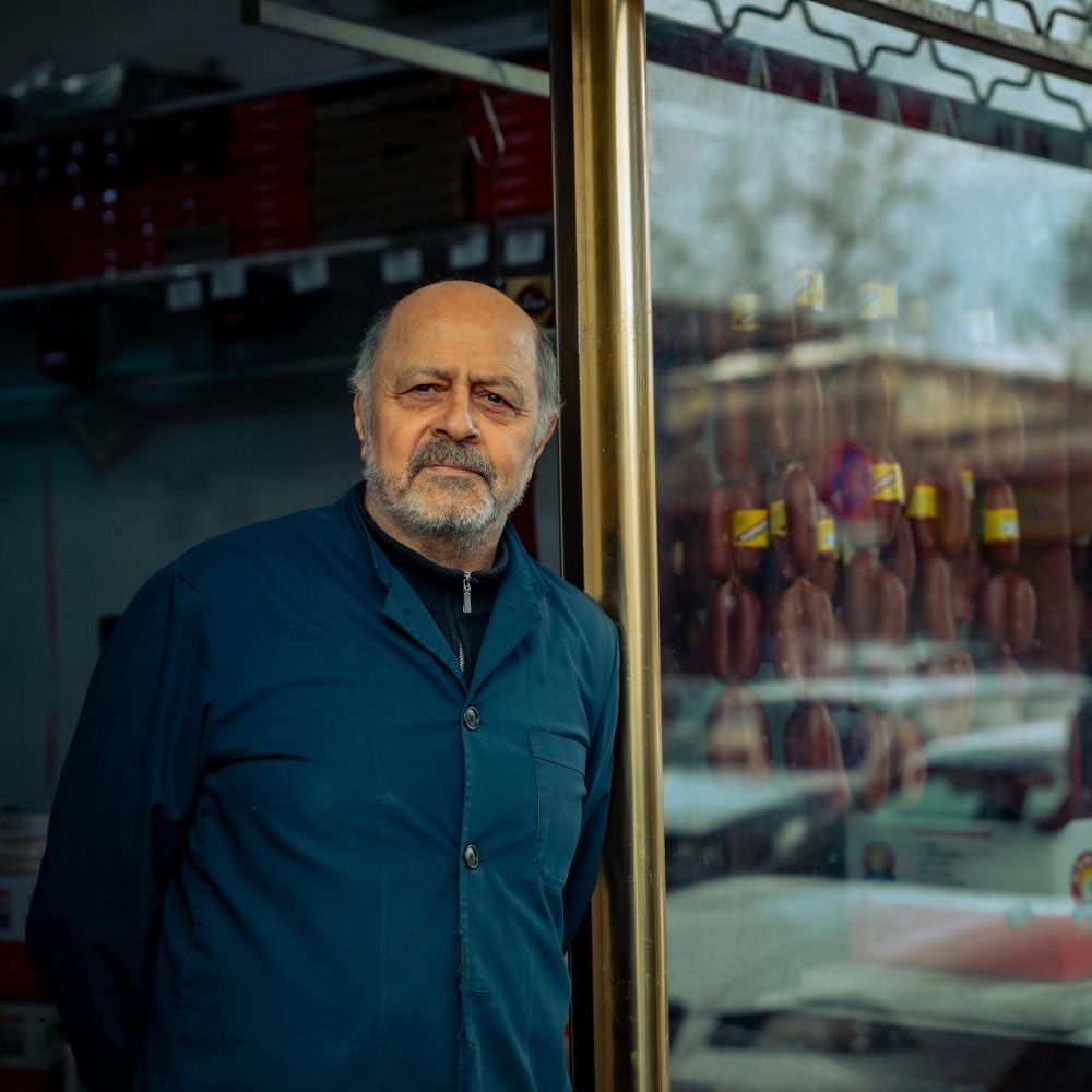 Small business owner standing in the doorway of his shop, where MCA creditors are not permitted to enter