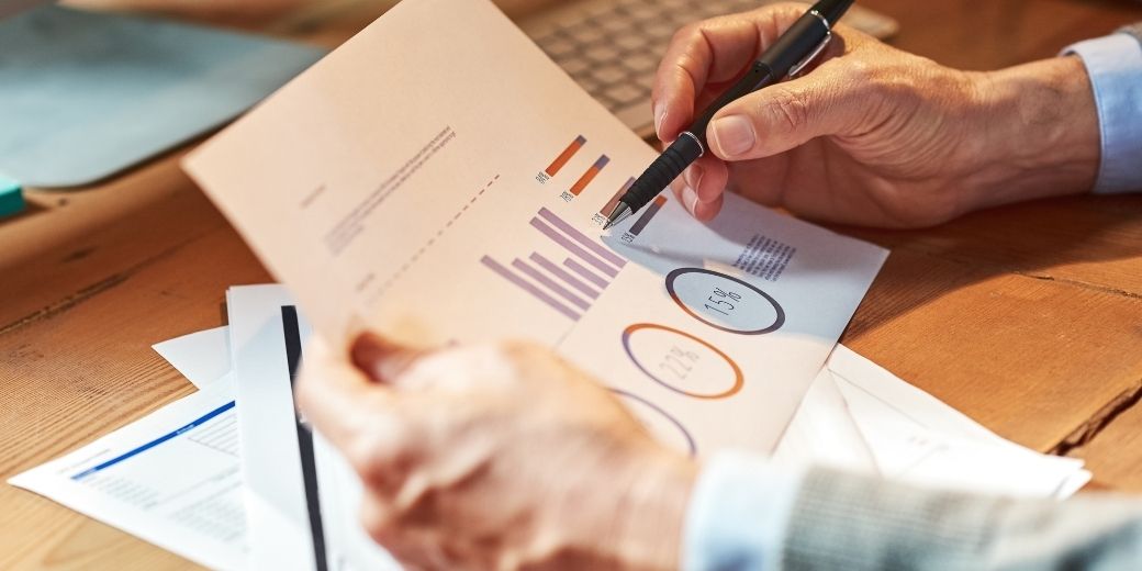 ClearBizDebt specialist reviewing a merchant cash advance debt settlement report