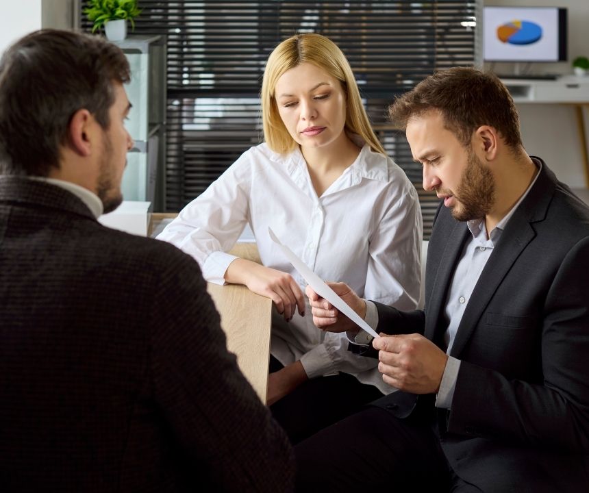Business owner reviewing MCA debt defense and settlement options with an advisor