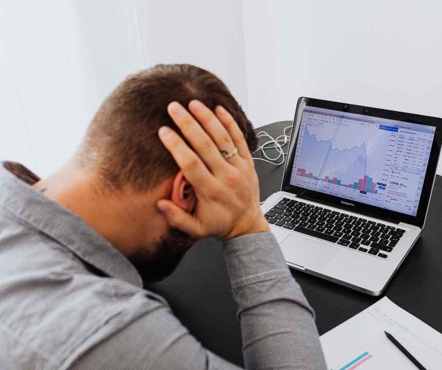 Business owner reviewing a draining bank account while deciding whether to stop paying a merchant cash advance