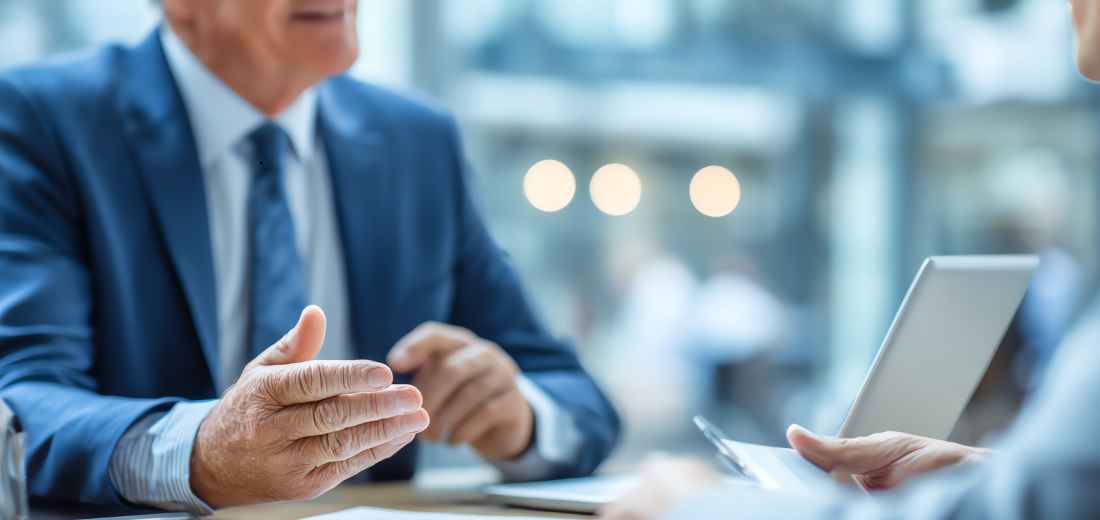 Business owner reviewing an attorney-backed settlement program and escrow plan with a specialist