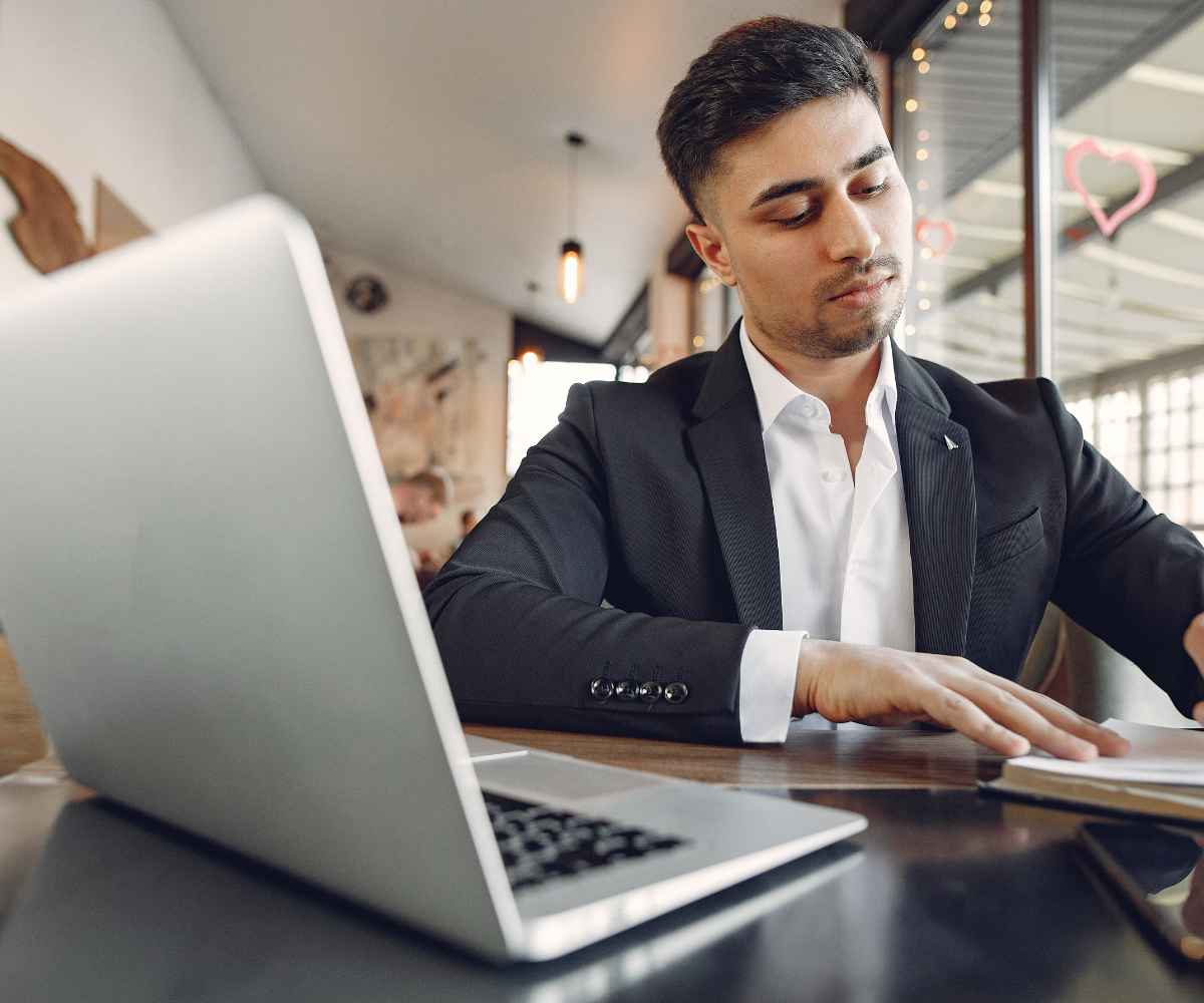 Business owner comparing Business Debt Adjusters reviews against other merchant cash advance relief options