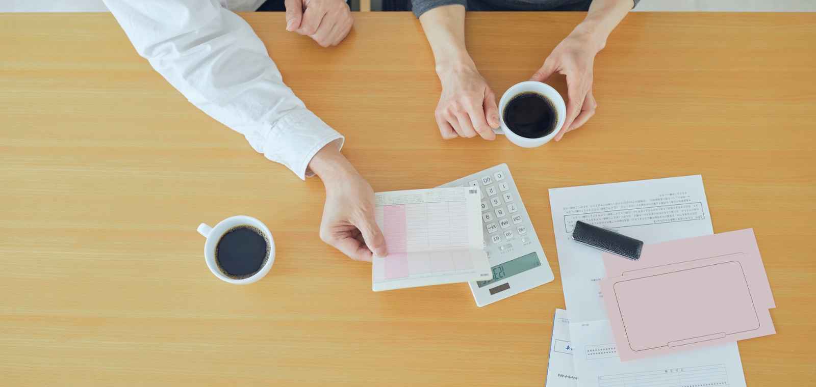 Business owner reviewing an MCA debt program fee schedule and contract before signing