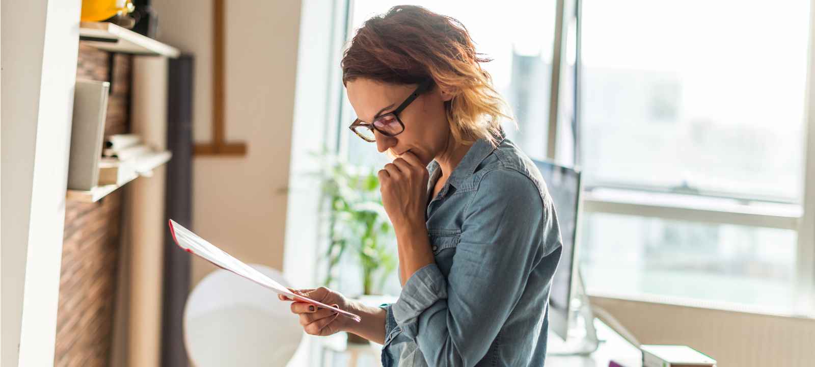 Business owner working through a checklist to verify a merchant cash advance settlement company