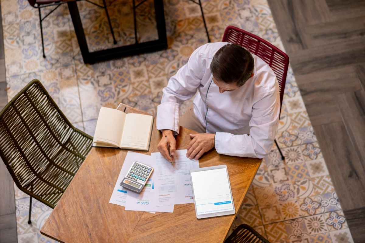 Business owner weighing a full-repayment program against a debt settlement program